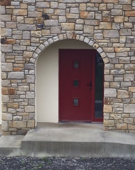 Entrance area on sandstone house wall 